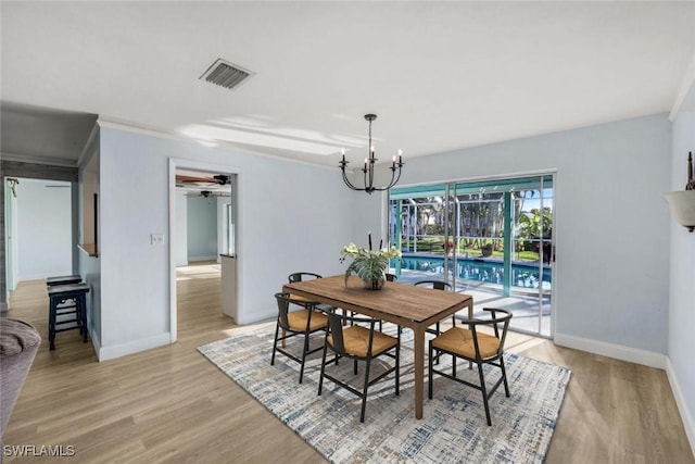 dining space featuring visible vents, baseboards, light wood-style floors, and ceiling fan with notable chandelier