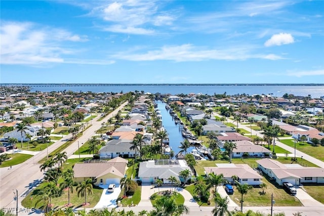 drone / aerial view featuring a residential view and a water view