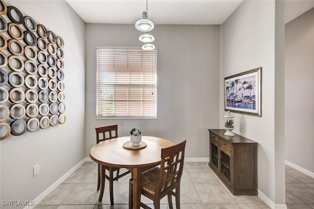 dining area featuring light tile patterned flooring and baseboards