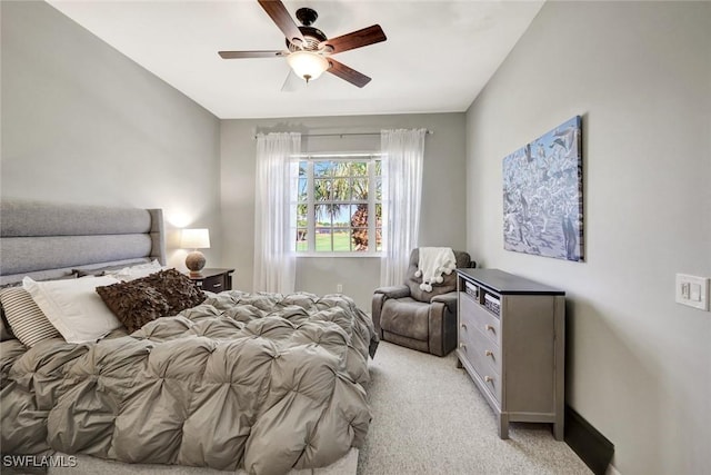 bedroom featuring light colored carpet and a ceiling fan