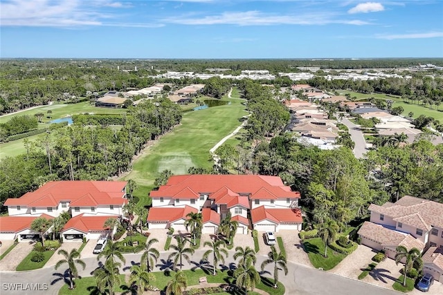 aerial view featuring a residential view, golf course view, and a water view