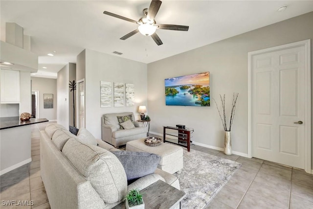 living room featuring light tile patterned floors, baseboards, visible vents, and ceiling fan