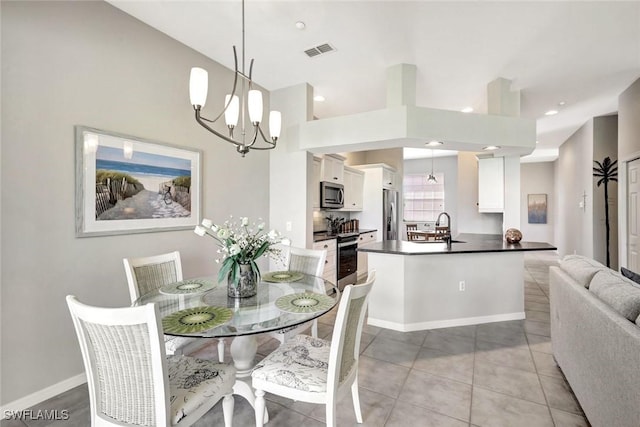 dining area with light tile patterned floors, baseboards, visible vents, recessed lighting, and a notable chandelier