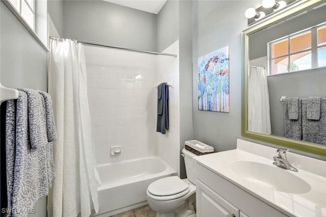 bathroom with shower / tub combo with curtain, toilet, and vanity