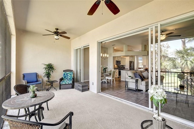 sunroom / solarium featuring a ceiling fan