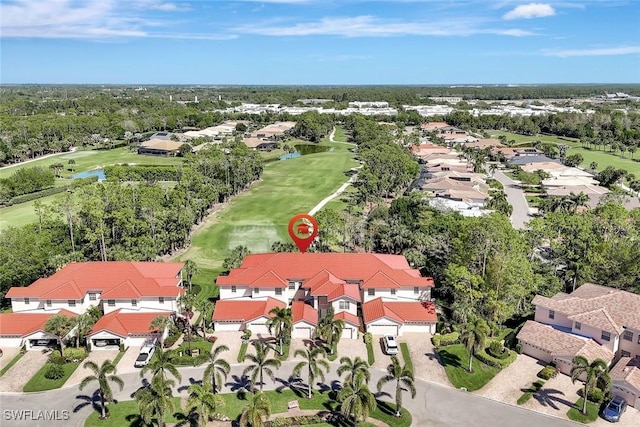 aerial view with a residential view, view of golf course, and a water view