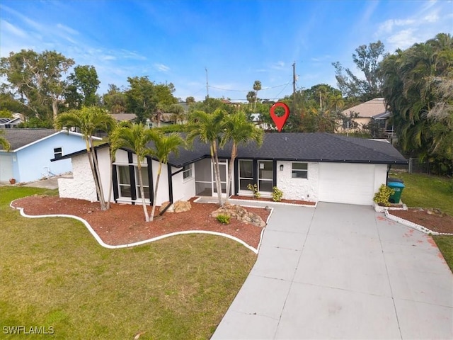 ranch-style home featuring stucco siding, concrete driveway, a garage, and a front yard