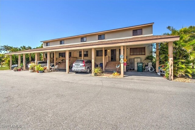 13508 Siesta Pines Ct Unit 7, Fort Myers, FL 33908 - view of front of property featuring covered parking and covered porch