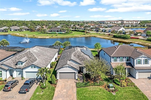 drone / aerial view with a residential view and a water view