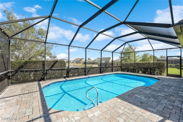 outdoor pool featuring a lanai and a patio area