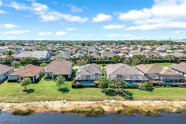 drone / aerial view with a residential view and a water view