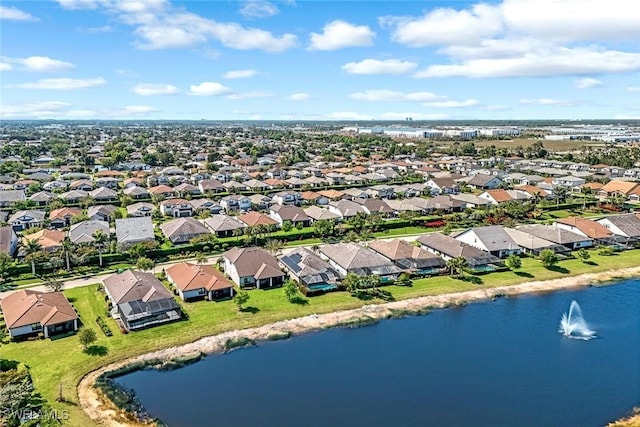 drone / aerial view featuring a residential view and a water view