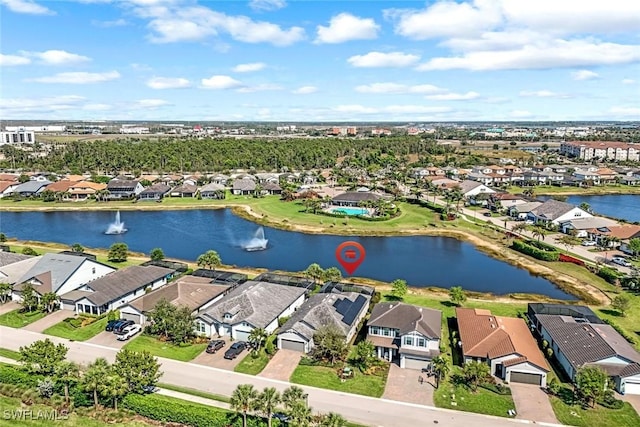 drone / aerial view with a residential view and a water view