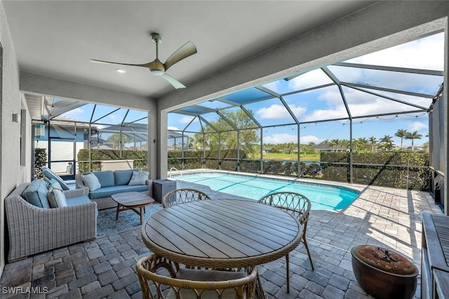 outdoor pool featuring a lanai, ceiling fan, an outdoor hangout area, and a patio