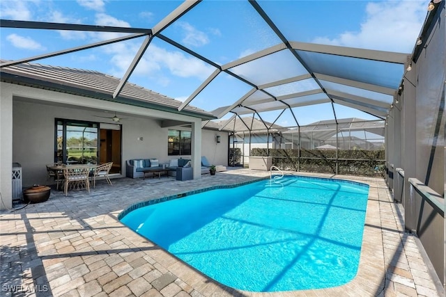 pool featuring an outdoor living space, a patio area, a lanai, and ceiling fan