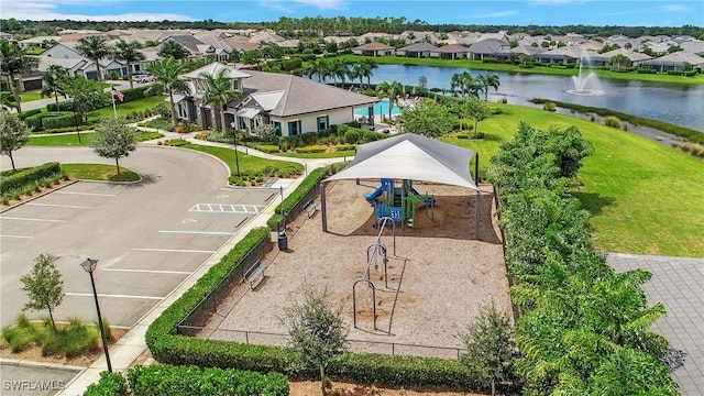 drone / aerial view with a residential view and a water view