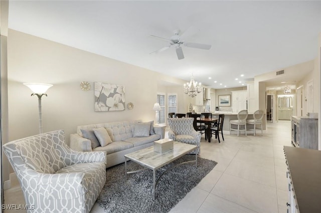 living room with recessed lighting, light tile patterned floors, ceiling fan with notable chandelier, and visible vents