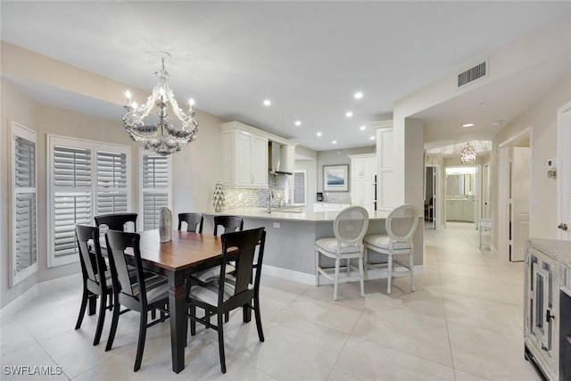 dining area featuring an inviting chandelier, recessed lighting, visible vents, and baseboards