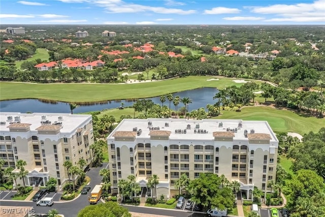 birds eye view of property featuring golf course view and a water view