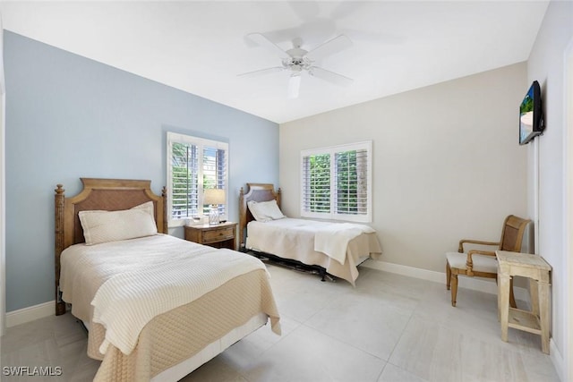 bedroom with baseboards, multiple windows, and ceiling fan