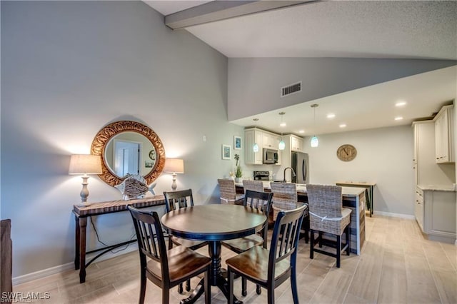 dining area with visible vents, baseboards, beam ceiling, recessed lighting, and light wood-style floors