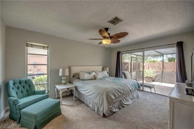 bedroom with access to outside, carpet flooring, visible vents, and ceiling fan