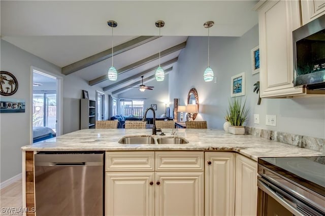 kitchen featuring light stone counters, appliances with stainless steel finishes, a wealth of natural light, and a sink