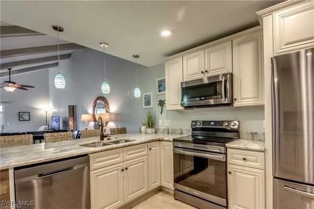 kitchen with light stone counters, appliances with stainless steel finishes, a peninsula, a ceiling fan, and a sink