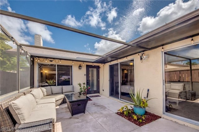 view of patio / terrace with an outdoor hangout area and fence