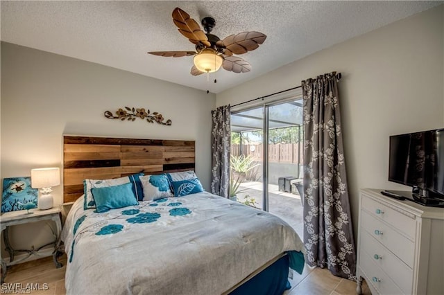 bedroom with a textured ceiling, access to exterior, and a ceiling fan