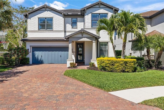 7111 Barnsbury Ln, Naples, FL 34109 - view of front of home featuring decorative driveway, a front yard, and an attached garage