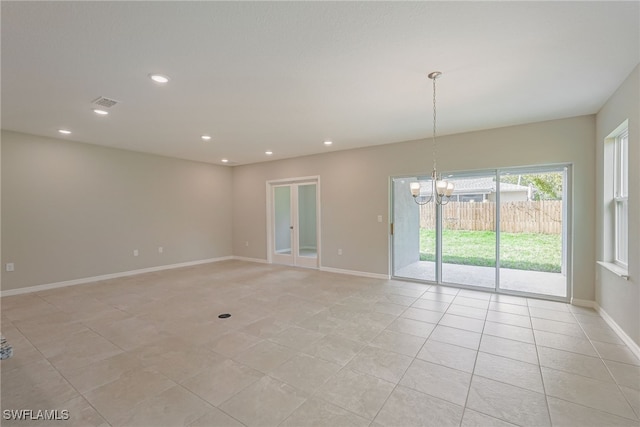 empty room with visible vents, a notable chandelier, recessed lighting, and baseboards