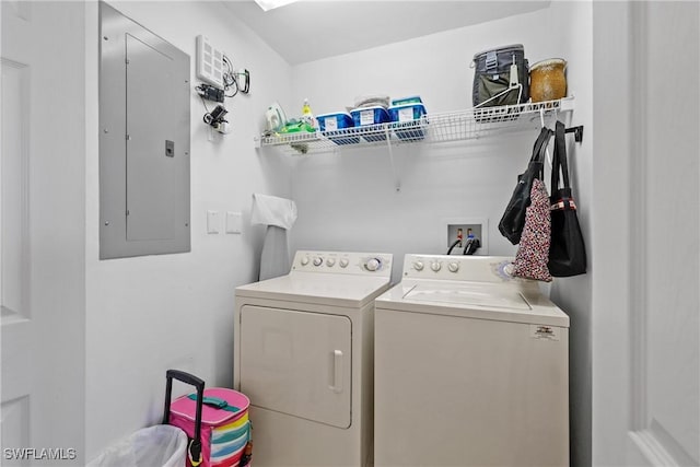 clothes washing area with electric panel, laundry area, and separate washer and dryer