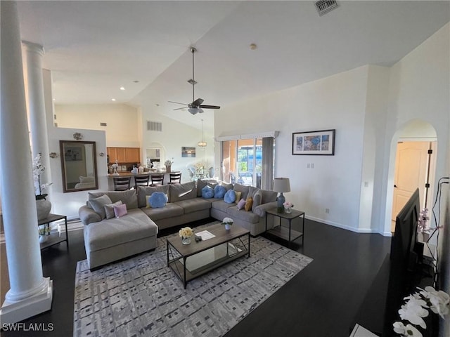 living area featuring baseboards, visible vents, high vaulted ceiling, arched walkways, and ceiling fan