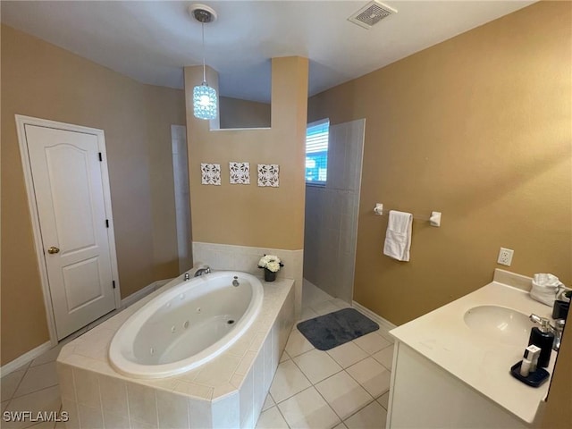 full bathroom with visible vents, vanity, a whirlpool tub, and tile patterned flooring