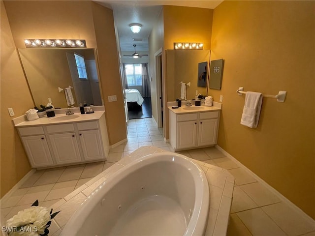 bathroom with two vanities, ensuite bathroom, a sink, a tub with jets, and tile patterned flooring