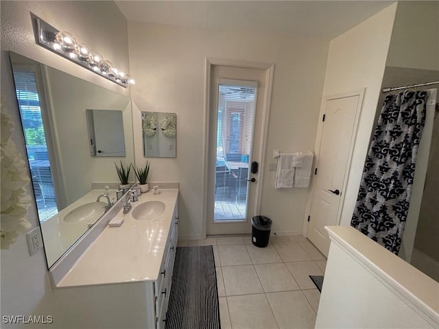 full bathroom featuring a sink, a shower with curtain, double vanity, and tile patterned flooring