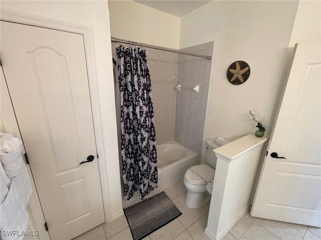 full bath featuring tile patterned floors, shower / bath combination with curtain, and toilet