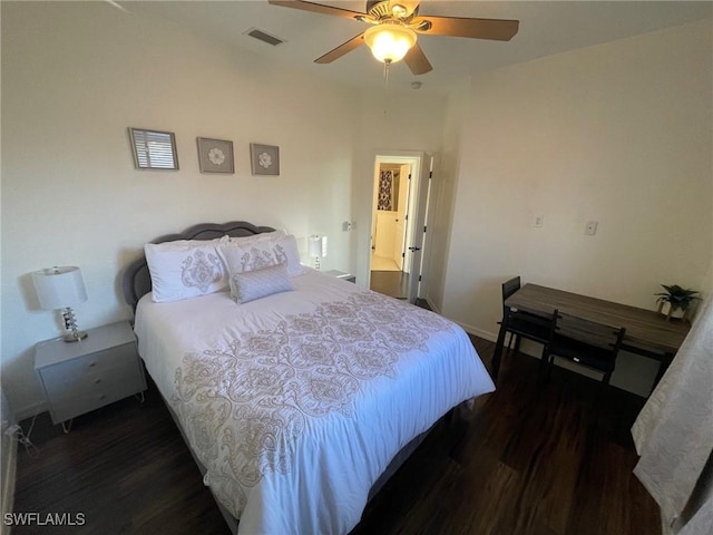 bedroom featuring visible vents, baseboards, ceiling fan, and wood finished floors