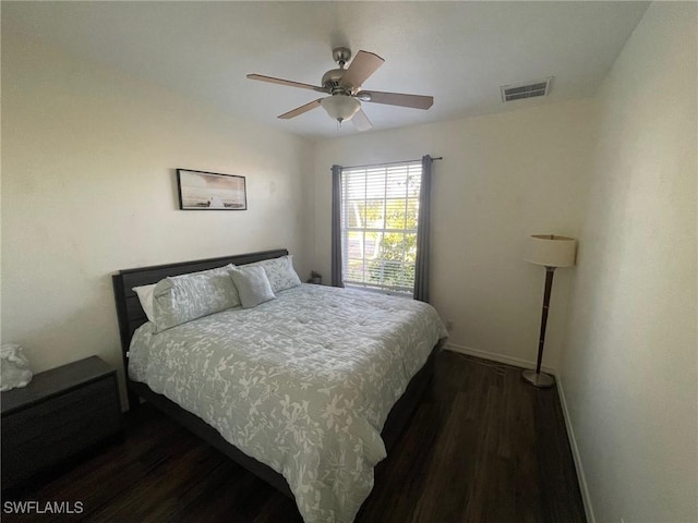 bedroom with visible vents, ceiling fan, baseboards, and dark wood-style flooring