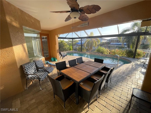 sunroom / solarium with a pool and ceiling fan