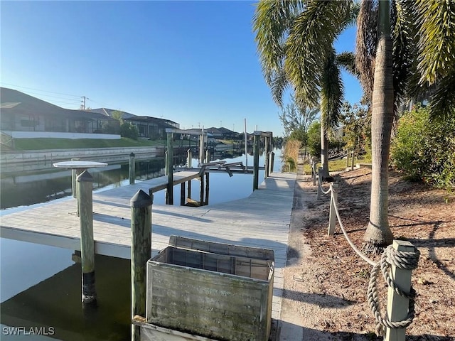 view of dock with a residential view and boat lift