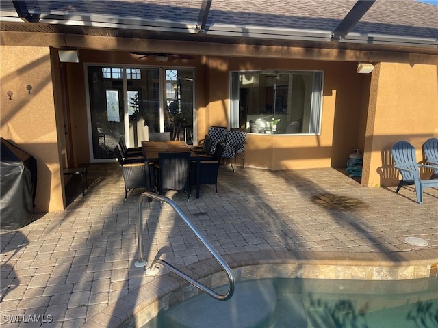 view of patio / terrace featuring outdoor dining area and a lanai