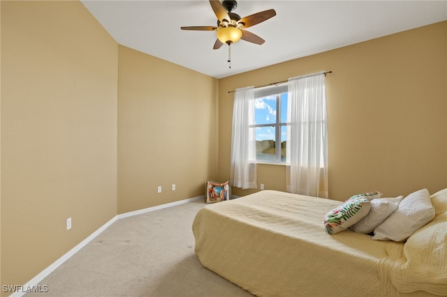 carpeted bedroom with a ceiling fan and baseboards