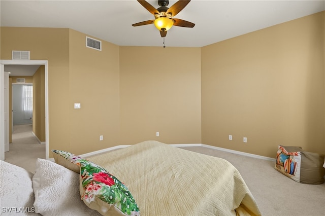 bedroom with visible vents, light carpet, baseboards, and ceiling fan