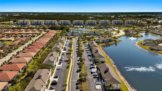 drone / aerial view featuring a water view and a residential view