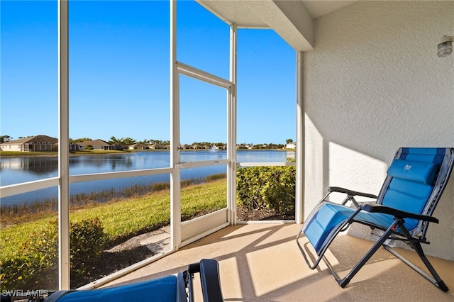 sunroom featuring plenty of natural light and a water view