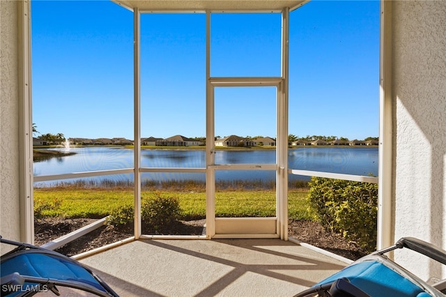 unfurnished sunroom with a water view