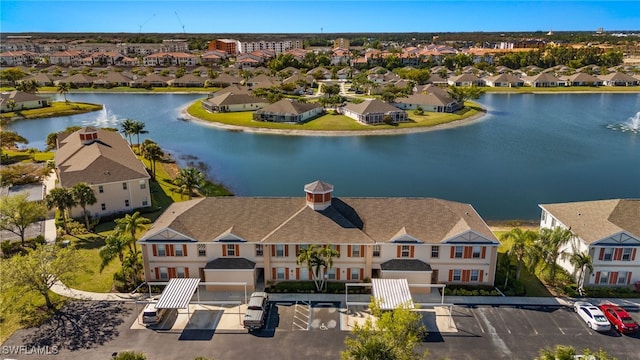 birds eye view of property with a residential view and a water view