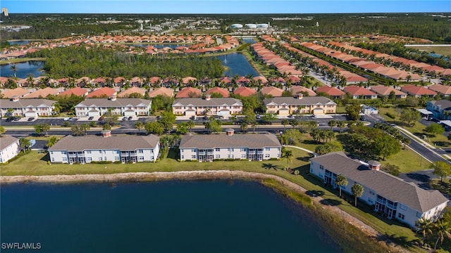 drone / aerial view featuring a residential view and a water view